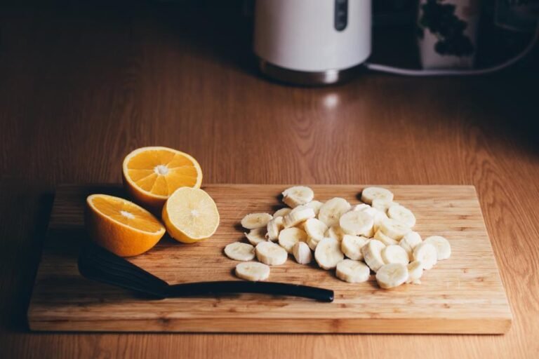 Sliced bananas and halved oranges on a wooden board, prepared as food for a ride